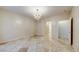 Neutral bedroom featuring stone floors and a decorative chandelier at 283 Auster Park Ave, Las Vegas, NV 89148