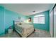 Stylish bedroom with a vibrant turquoise wall, cozy bed, and closet at 283 Auster Park Ave, Las Vegas, NV 89148
