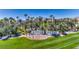 Entrance to Rhodes Ranch with abundant palm trees and manicured lawns at 283 Auster Park Ave, Las Vegas, NV 89148