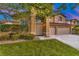 Beautiful two-story home featuring a well-maintained lawn and lush landscaping at 283 Auster Park Ave, Las Vegas, NV 89148