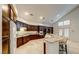 Bright kitchen boasts granite countertops, dark wood cabinetry, and a large island with barstool seating at 283 Auster Park Ave, Las Vegas, NV 89148