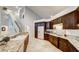 Well-lit kitchen includes granite counters, stainless appliances, and a breakfast bar with seating at 283 Auster Park Ave, Las Vegas, NV 89148