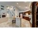 Open concept kitchen featuring granite counters, dark wood cabinets, and a breakfast bar with seating at 283 Auster Park Ave, Las Vegas, NV 89148
