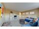 Spacious living room with carpet, display shelving, and natural light at 283 Auster Park Ave, Las Vegas, NV 89148