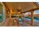 Relaxing covered patio area overlooking a pool and lush landscaping, ideal for outdoor entertaining at 283 Auster Park Ave, Las Vegas, NV 89148