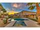 Stunning backyard oasis with a sparkling pool, hot tub, and lush landscaping, perfect for relaxation at 283 Auster Park Ave, Las Vegas, NV 89148
