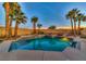 A pristine backyard pool and spa with lush palms and a fun slide, perfect for outdoor fun at 283 Auster Park Ave, Las Vegas, NV 89148