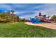 Community waterpark featuring colorful slides, splash zone, and lush landscaping with tall palm trees at 283 Auster Park Ave, Las Vegas, NV 89148