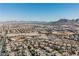 This aerial shows a desert community featuring baseball diamonds, lush landscaping, and mountain views in a sunny location at 299 Francisco St, Henderson, NV 89014