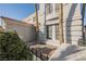 Charming home exterior featuring an entry courtyard with shade trees, a tile roof, and beautiful stonework at 299 Francisco St, Henderson, NV 89014