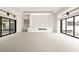 Bright living room with a fireplace, tile floors, and two sliding glass doors leading to the backyard at 3430 Cosima Ln, Las Vegas, NV 89120