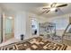 View of the bedroom with large patterned area rug, ceiling fan, bunk beds and walk-in closet at 3491 Bankside Dr, Las Vegas, NV 89129