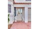 Elegant front entrance featuring a decorative glass door flanked by charming decorative cat statues and lush landscaping at 3491 Bankside Dr, Las Vegas, NV 89129