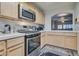 Well-equipped kitchen featuring light wood cabinets and stainless steel appliances at 3491 Bankside Dr, Las Vegas, NV 89129