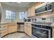 Cozy kitchen with stainless steel appliances and a window overlooking the yard at 3491 Bankside Dr, Las Vegas, NV 89129