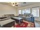 Comfortable living room with large sectional sofa, windows, and a ceiling fan at 3491 Bankside Dr, Las Vegas, NV 89129
