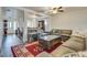Open-concept living area with a large sofa, area rug, and lots of natural light at 3491 Bankside Dr, Las Vegas, NV 89129