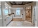 Luxurious bathroom featuring a soaking tub, tiled shower, and vanity with ample counter space at 360 E Desert Inn Rd # 604, Las Vegas, NV 89109