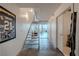 Modern condo hallway with concrete floors and open staircase to living area with city views at 360 E Desert Inn Rd # 604, Las Vegas, NV 89109