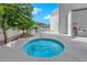 Outdoor hot tub with clear blue water surrounded by a patio and green landscaping at 360 E Desert Inn Rd # 604, Las Vegas, NV 89109