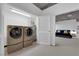 Functional laundry room with washer, dryer and water heater, leading into a bedroom with modern decor at 360 E Desert Inn Rd # 604, Las Vegas, NV 89109