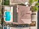 Aerial view of backyard featuring a large pool, spa, solar panels, and covered patio at 4045 Abernethy Forest Pl, Las Vegas, NV 89141