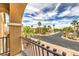 Stunning balcony view overlooking a peaceful street lined with lush palm trees and beautiful landscaping at 4045 Abernethy Forest Pl, Las Vegas, NV 89141