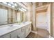 Bathroom with double sinks, large mirror, and a shower over tub combo at 4045 Abernethy Forest Pl, Las Vegas, NV 89141