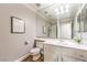 Neutral bathroom with a single vanity, a large mirror, and a shower over tub at 4045 Abernethy Forest Pl, Las Vegas, NV 89141