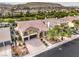 Charming home with a red tiled roof, two-car garage, and lush palm tree landscaping at 4045 Abernethy Forest Pl, Las Vegas, NV 89141