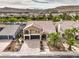 Elegant home with a red tiled roof, well-manicured landscaping, and a paver driveway at 4045 Abernethy Forest Pl, Las Vegas, NV 89141