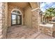 Arched front entry with stone accents and double glass doors at 4045 Abernethy Forest Pl, Las Vegas, NV 89141