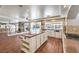 Open kitchen features wood floors, large island and stainless steel appliances, perfect for entertaining at 4045 Abernethy Forest Pl, Las Vegas, NV 89141