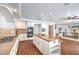 Spacious kitchen with wood floors, a center island, and stainless steel appliances at 4045 Abernethy Forest Pl, Las Vegas, NV 89141