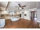 Spacious eat in kitchen featuring wood floors, white cabinets, and center island at 4045 Abernethy Forest Pl, Las Vegas, NV 89141