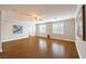 Bright and airy living room with wood floors, plantation shutters, and modern decor at 4045 Abernethy Forest Pl, Las Vegas, NV 89141