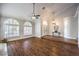 Bright living room showcasing vaulted ceilings, wood flooring and elegant chandelier lighting at 4045 Abernethy Forest Pl, Las Vegas, NV 89141