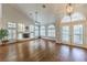 Spacious living room with wood floors, fireplace, and plantation shutters for bright natural light at 4045 Abernethy Forest Pl, Las Vegas, NV 89141