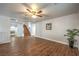 Bright living room with wood floors, staircase access, and neutral paint at 4045 Abernethy Forest Pl, Las Vegas, NV 89141