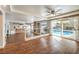 Bright open living room with pool view, wood floors, and white railings at 4045 Abernethy Forest Pl, Las Vegas, NV 89141