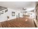Spacious living room with wood floors, fireplace, and staircase at 4045 Abernethy Forest Pl, Las Vegas, NV 89141