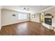 Living room with fireplace, wood floors, and bright window light at 4045 Abernethy Forest Pl, Las Vegas, NV 89141