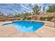 Sparkling blue pool with integrated spa and relaxing patio area at 4045 Abernethy Forest Pl, Las Vegas, NV 89141
