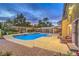 Beautifully designed backyard features a custom pool, spa, covered pergola, outdoor kitchen, and mature landscaping at 4045 Abernethy Forest Pl, Las Vegas, NV 89141