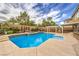Beautiful backyard pool and spa with an outdoor kitchen and shaded pergola area at 4045 Abernethy Forest Pl, Las Vegas, NV 89141