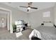 Neutral bedroom features a ceiling fan and a bed with storage underneath at 409 Wind Poppy St, Las Vegas, NV 89138