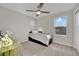 Neutral bedroom features a ceiling fan and a bed with storage underneath at 409 Wind Poppy St, Las Vegas, NV 89138