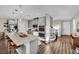 Modern kitchen featuring a long center island with seating, sleek gray cabinets, and luxury vinyl plank flooring throughout at 409 Wind Poppy St, Las Vegas, NV 89138