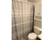 Bathroom featuring a decorative shower curtain and a convenient storage cabinet at 4368 Vornsand Dr, Las Vegas, NV 89115