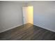 Bedroom with wood-look flooring, white trim, and an open door to another room at 4368 Vornsand Dr, Las Vegas, NV 89115